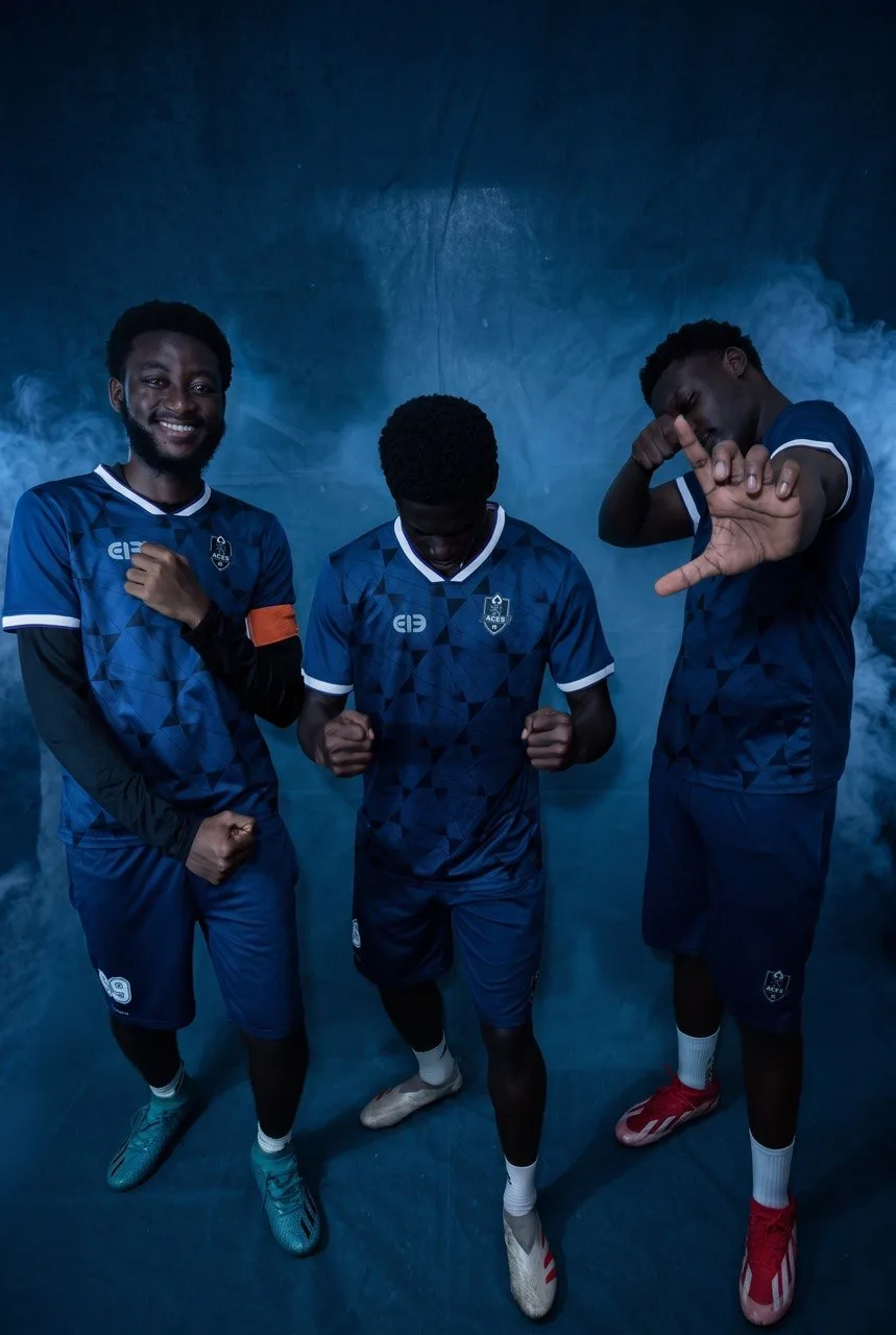 Three Aces FC players posing together in the blue home kit.