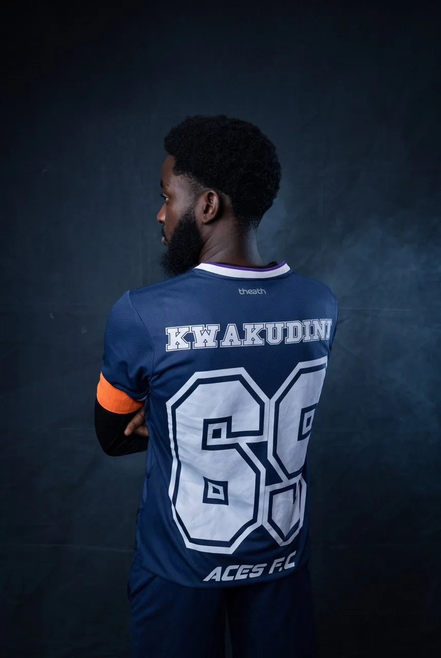 The back of an Aces FC shirt, showing the club name above the squad number, worn with a captain's armband.