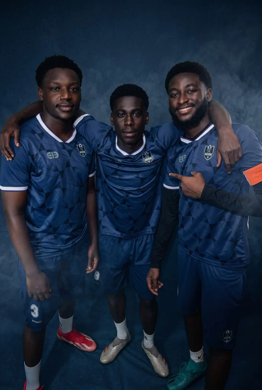 Three Aces FC players standing together in the blue home kit.